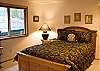The lovely master bedroom has a queen size bed, with a TV, and has its own bathroom.  A door leads right outside to the steaming hot tub.
