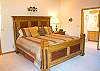 The Master Bedroom is on the main floor and features an elegant King Size Bedroom set.  This room has a door to the deck, rocking chair, TV, DVD, walk-in closet, jacuzzi tub with separate shower.