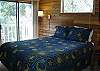 Second picture of the cozy and warm bedroom upstairs with a Queen Bedroom.  Let the breeze in from the balcony.