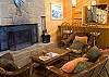 Cozy seating area with wood burning fire place and bar area.