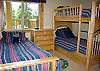 Kid's room downstairs features a set of bunkbeds, as well as a twin size bed with a trundle.  Room also features a walk-in closet.