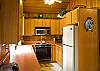 The kitchen connects with the dining room. The wood accents give it a warm feel.