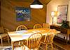 Dining room seats six comfortably. It is nice and bright with hard wood floors and attractive area rug.