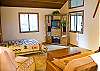 The den has a queen size murphy bed and sitting area.