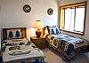 This main floor bedroom features Two Twin Size Beds.  The bathroom is right next door off the hallway.