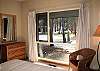 Queen Bedroom offers views of common area.