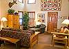 Enjoy the many colorful quilts adorning this bright and cheerful living room. This home is cute, cozy and comfy.