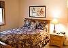 The third bedroom of this house has a queen size bed, as well as its own TV. The hall bathroom is right next door.