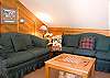 Sitting area with game table at the top of the stairs in the loft.