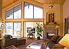 Light and bright living room with fireplace and nice view off deck. New large flat screen TV.
