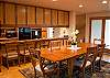 Dining table has seating for 6 and 4 additional seats at the breakfast bar.