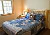 This cute queen bedroom with TV shares a hall bathroom with the twin room.