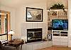 Another view of the living room showing the fireplace.