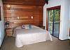 Upstairs master king has small deck, a corner wood stove, TV/VHS and master bath has a shower.