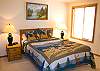 This main floor bedroom features a Queen Size Bed and shares a hall bathroom.