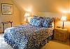 You can relax in this upstairs Queen Loft Bedroom with TV, chair and bathroom.