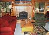 Cozy living room with wood burning fireplace.