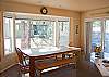 Large dining table with 2 chairs and bench seating for all.