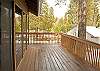 Large deck with patio furniture and propane BBQ.