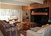 Large and cozy living room with a wood burning fireplace.