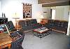 Living room with comfortable couches and a rocking chair.