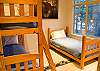 One of two kids' rooms in this home.  This one features a set of bunk beds as well as a twin.  Room also has a TV and game system.