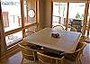 View of dining room from living room and looking out towards door to deck and hot tub.