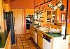 Lots of cupboard space, a hanging pot rack for quick access to pots and pans while cooking and entertaining.