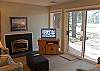 Comfortable living room with gas fireplace, a flat screen TV and a great view.