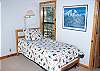 Another view of one of the single beds in the upstairs loft bedroom.