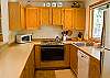 The galley style kitchen is open to the dining room and breakfast bar.