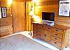 This Master Bedroom Suite has a King Size Bed, a flat screen T.V.,  a bathroom with Tub/shower and two sinks.