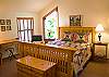 Beautiful Queen Bedroom with its own sky light, stained glass window, bathroom and cozy sitting area.