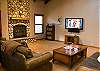 Imagine the great times to be had in this warmly decorated great room!  Complete with cozy furniture, large HDTV, high vaulted ceilings and gas fireplace.