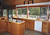 Large windows provide views in all directions. Kitchen spacious and room for everyone help.
