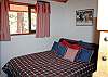 The queen bed in the bunk and queen area.