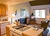 An open great room provides a relaxed gathering place for everyone, including the chef, to enjoy comfort and company in this condo.