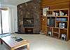 Large stone fireplace and entertainment center.