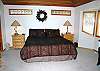 A beautiful master bedroom with a chair and carved bench, large walk-in closet, large bath with 2 sinks and large shower.  Also, may enjoy alone time with TV/DVD/VHS.