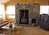 Large flat screen television and nice wood burning stove.