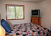 A second upstairs bedroom features a queen size bed, complete with TV.
Nearby bathroom in hallway.