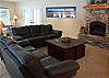 Another view of this beautiful great room. Cozy up around the fire and get comfortable in the leather upholstered couches.