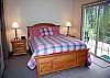Queen Master Bedroom with walk-in closet, bath with shower and door to deck and hot tub.