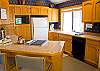 This kitchen is open to the dining area with a breakfast bar that seats two.