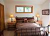 This is the second of the four bedrooms. It also features a Queen Size Bed and a TV. This room is also attached to a hall bathroom.