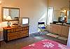 Upstairs Queen Bedroom has TV with built in DVD and VCR Bnd a two sink vanity.