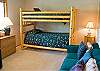 The second Bedroom downstairs features a Set of Bunks, couch and love seat, TV, VHS.  Kids will love this room!