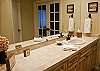 Beautiful Master Bathroom with tile counters and hard wood cabinetry.