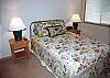 This second of four bedrooms in this home, this one features a queen size bed, TV, and a walk-in-closet.  The bathroom is right next door in the hallway.  This bedroom is to the left of the living room.