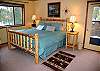 Nice rustic Master King Suite with a private bathroom and deck leading to hot tub.